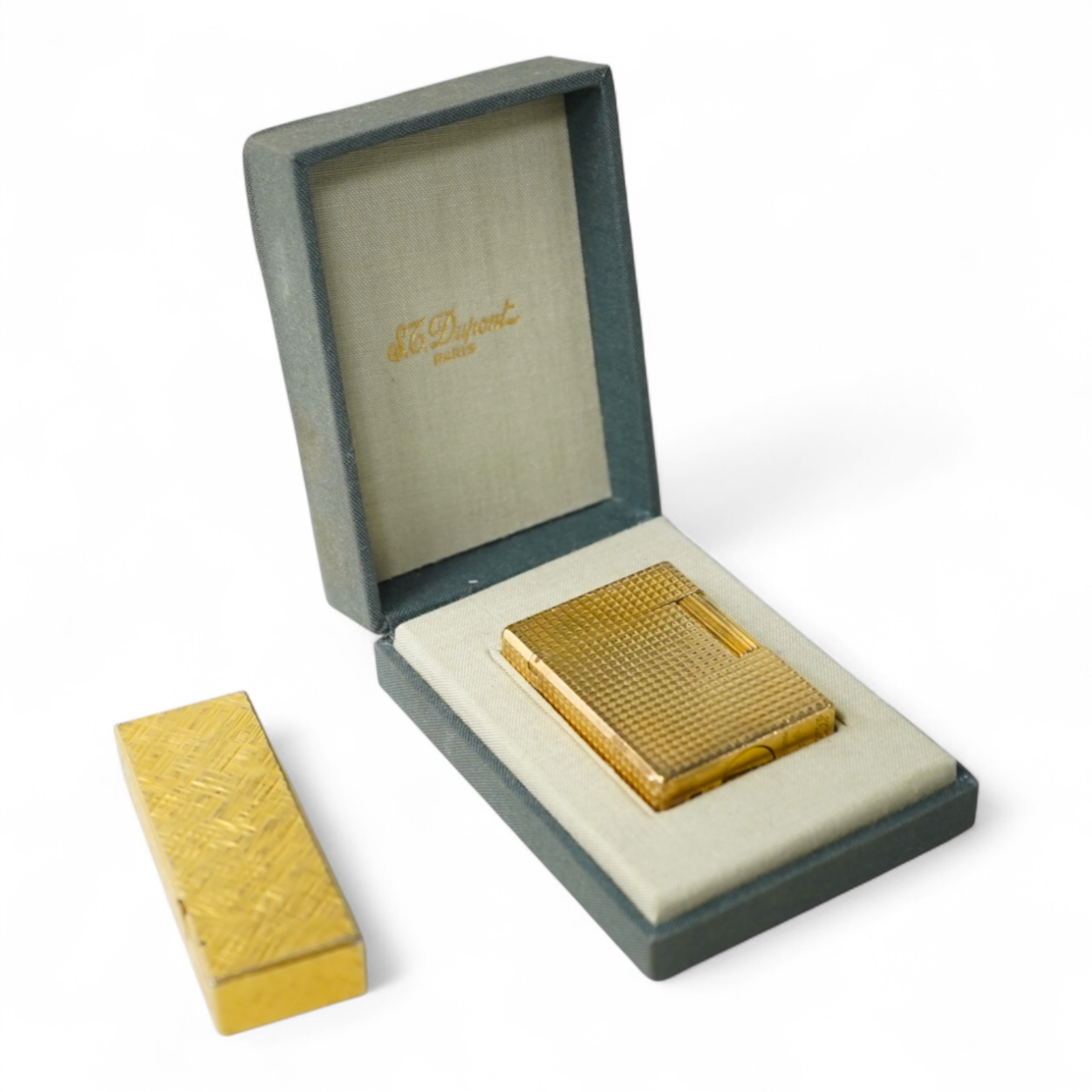 A cased DuPont lighter with booklet and a Dunhill rollagas example
